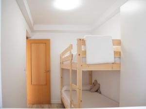 a bunk bed in a room with a door at Jamaica Beach House in Puebla de Farnals +64 photos