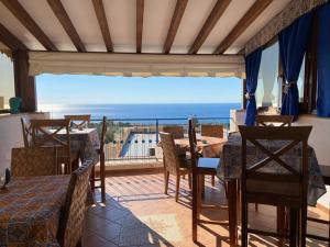 a dining room with a view of the ocean at Hellas Makari B&B in Macari