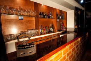 a bar with a counter with alcohol bottles and a basket at El Jacal Classic in Huaraz