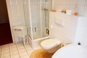 a white bathroom with a shower and a toilet at Apartment in Euskirchen in Euskirchen
