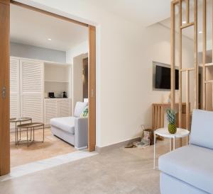 a living room with a couch and a chair at Antigoni Seaside Resort in Ormos Panagias