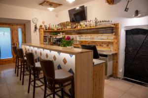 a bar in a restaurant with a fireplace at Landhotel Pacher in Obervellach