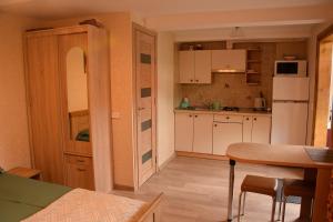 a kitchen with a table and a white refrigerator at Fisherman´s House in Nida