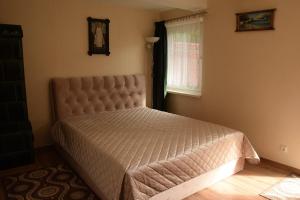 a bedroom with a bed in a room with a window at Fisherman´s House in Nida