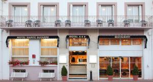 a facade of a hotel with a hotel sample name on it at Hôtel Sainte Suzanne in Lourdes