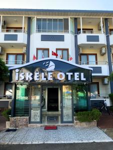 a hotel with a sign that reads justice otel at İskele Otel in Tasucu