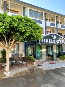 a building with a tree in front of it at İskele Otel in Tasucu