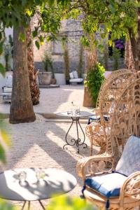 a patio with chairs and a table and trees at Hotel Supetar in Cavtat