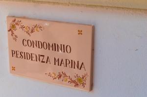 Un cartello su un muro che legge condominatiores na mariana di BAIA VERDE 22 a Gallipoli