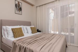 a bedroom with a bed and a large window at Selozia Apartment in Zakynthos