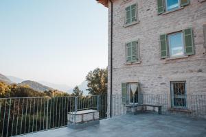 a balcony of a brick building with a fence at Casa del Parco Adamello in Cevo