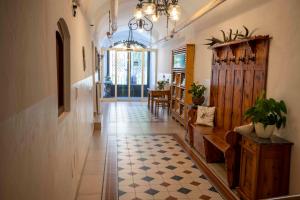 a hallway with a room with a table and a chandelier at Landhotel Pacher in Obervellach