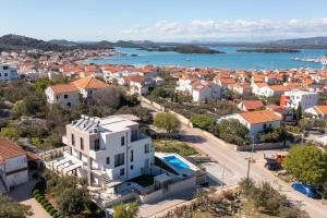 an aerial view of a town with a river and houses at Villa Magna luxury apartments in Murter