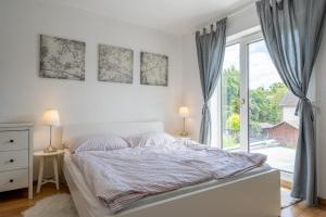 a bedroom with a bed and a large window at Private House in Hannover
