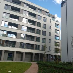 an apartment building with a pathway in front of it at Plac Unii: Rybka Premium in Gdynia