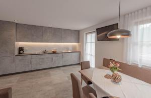 a kitchen and dining room with a table and chairs at Ortnerhof in San Giovanni in Val Aurina