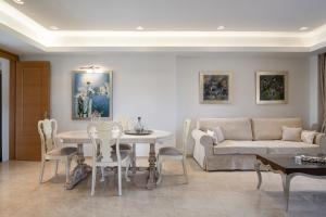 a living room with a table and a couch at Antigoni Seaside Resort in Ormos Panagias