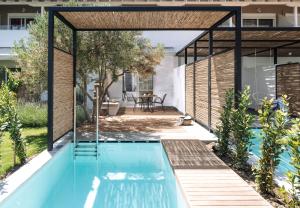 a swimming pool in a house with a glass extension at Antigoni Seaside Resort in Ormos Panagias