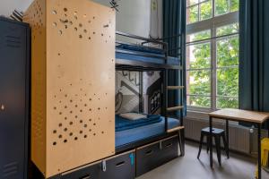 a climbing wall in a room with a table at Stayokay Hostel Amsterdam Vondelpark in Amsterdam