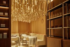 a dining room with a table and a chandelier at King Street Townhouse in Manchester