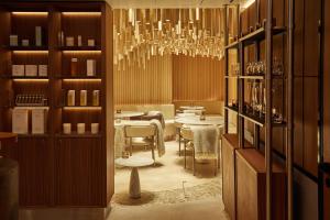 a dining room with a table and a chandelier at King Street Townhouse Hotel & Spa in Manchester