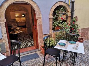 a table and chairs outside of a restaurant at Casa Pagiò in Bosa