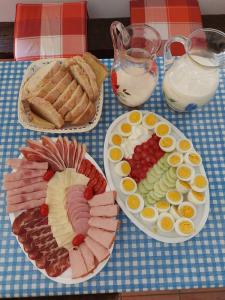 a table topped with plates of food on a table at Apartman Milica in Golubić