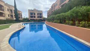 a large blue swimming pool in a building at Bonito Dúplex Msj 83 in Calafat
