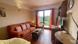 a living room with a couch and a window at Bonito Dúplex Msj 83 in Calafat