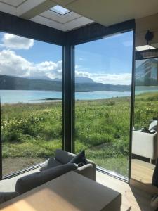 a living room with a view of the water at Steigen Lodge Tiny house in Steigen