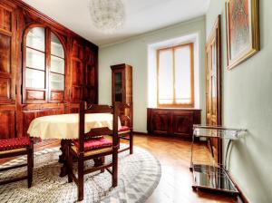 a room with a table and a chair in it at Tibaldi Sette in Domodossola