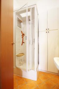 a glass shower in a bathroom with a sink at Tibaldi Sette in Domodossola +10 photos