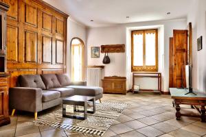 a living room with a couch and a table at Tibaldi Sette in Domodossola