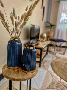 two blue vases sitting on a table in a living room at gemütlicher Bungalow x Garten & Terrasse x NETFLiX in Moshi