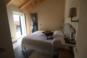 a bedroom with a bed and a table and a window at bbveleura in Velva
