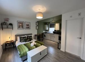 a small bedroom with a bed and a kitchen at The Green Room - Worthing in Worthing