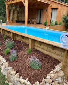 a swimming pool in a yard with a house at Lodge La Courrège in Larché +7 photos