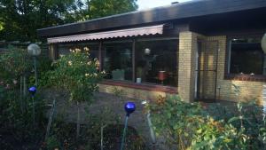 a house with blue spheres in the yard at Ferienhaus an der Förde in Flensburg +12 photos