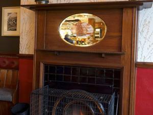 a mirror above a fireplace with a fire place at The Endeavour in Whitby