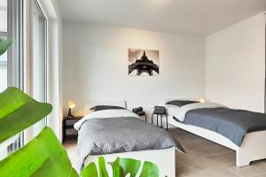 a bedroom with two beds and a window at Modern Apartment near Offenbach in Seligenstadt in Seligenstadt