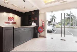 a store front with a home korea sign on the window at Hotel Home 88 in Teluk Intan