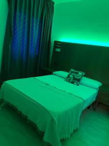a bed in a room with a lamp on top of it at Hostel can salvado in Cambrils
