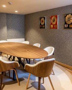 a conference room with a wooden table and chairs at Puente Romano Marbella in Marbella +37 photos