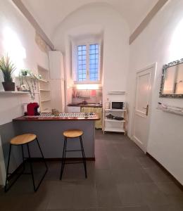 - une cuisine avec un comptoir et deux tabourets dans l'établissement Casa dei Gigli, à Pérouse
