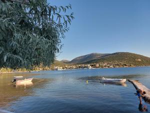 three boats on a lake with a mountain in the background at Vitamin sea Studio in Panayía