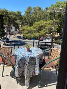 a table with a potted plant sits on a balcony at Voula Ilias Studios in Panormos Kalymnos