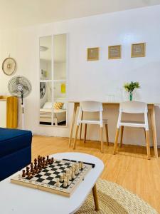 a living room with a chessboard on a table at SCANDINAVIAN THEMED-1BR CONDO-Marilao Bulacan-TheRichPlacePH 7 in Marilao