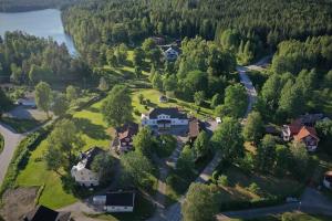 an aerial view of a house with a yard and a lake at Bredsjö Gamla Herrgård White Dream Mansion in Hällefors