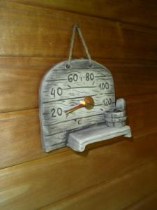 a clock hanging on a wooden wall at Walhalla apartment in Forssa