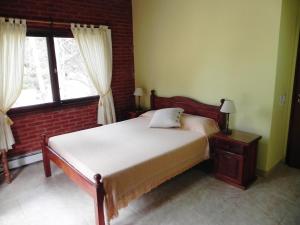 a bedroom with a bed and a large window at Acacias Blancas in Costa del Este